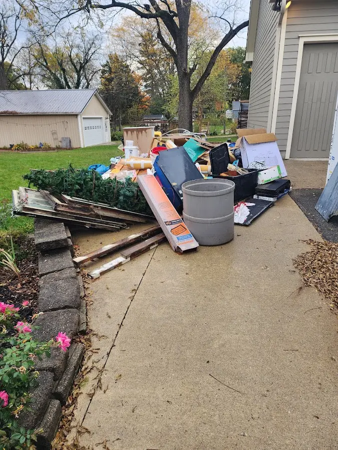 Dumpster being loaded with debris for 12 Yard Dumpster Rental in Gatlinburg